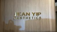 JEAN YIP COUNTER SIGNAGE STAINELSS STEEL GOLD WITH BACKLIT SIGNAGE