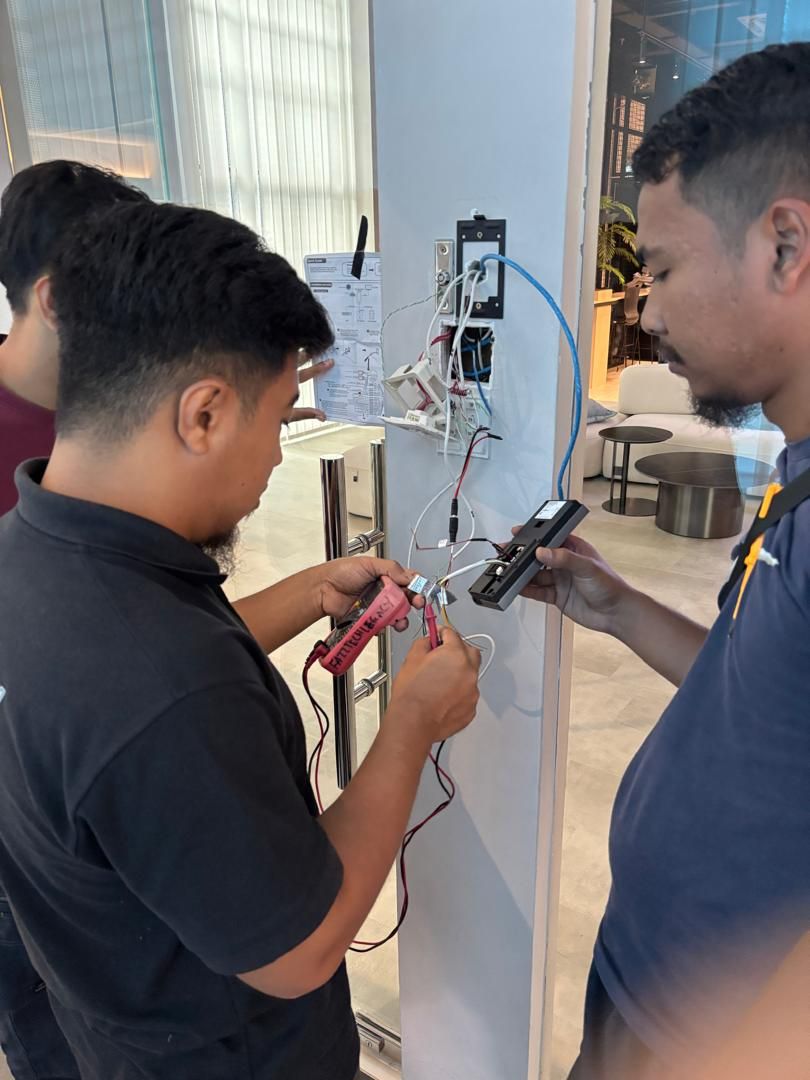 AC Security Solution technician installing cloud access control reader at Infinite EPC Sdn Bhd office in Mount Austin, Johor Bahru